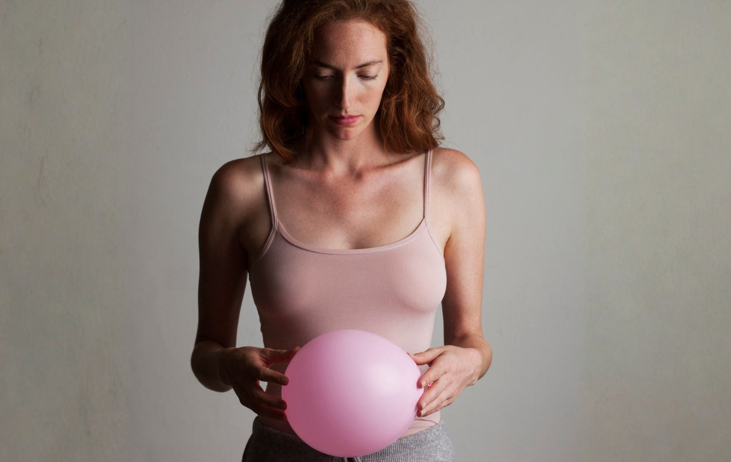 Woman holding a balloon to illustrate bloating. Summer Bloating Fix | Gut Health & Digestion Support